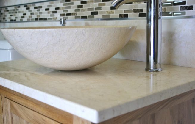 Close-up Side View of Cream Marble Basin on Cream Marble Top Vanity Unit