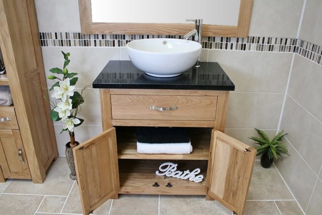 Front View of Round Curved White Ceramic Basin on Black Quartz Topped Oak Vanity Unit Showing Cupboard Storage