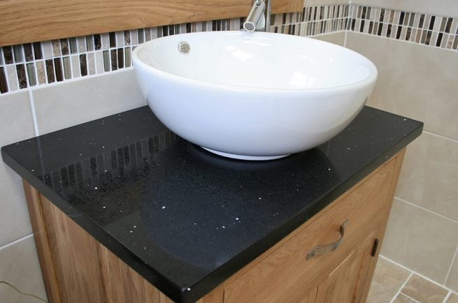 Side View of Round Curved White Ceramic Basin on Black Quartz Topped Oak Vanity Unit