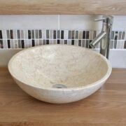 Close-Up of Cream Marble Basin on Oak Top
