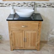 Front View of Oval White Ceramic Basin on Black Quartz Topped Oak Vanity Unit