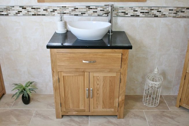 Front View of Oval White Ceramic Basin on Black Quartz Topped Oak Vanity Unit