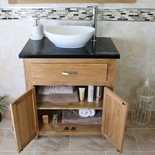 Front View of Oval White Ceramic Basin on Black Quartz Topped Oak Vanity Unit Showing Cupboard Storage