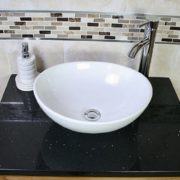 Above View of Oval White Ceramic Basin on Black Quartz Topped Oak Vanity Unit