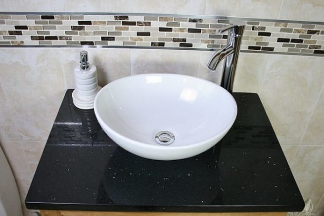 Above View of Oval White Ceramic Basin on Black Quartz Topped Oak Vanity Unit