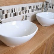 Close-up of Two Oval White Ceramic Basins on Big Oak Top Vanity Unit