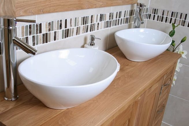 Close-up of Two Oval White Ceramic Basins on Big Oak Top Vanity Unit