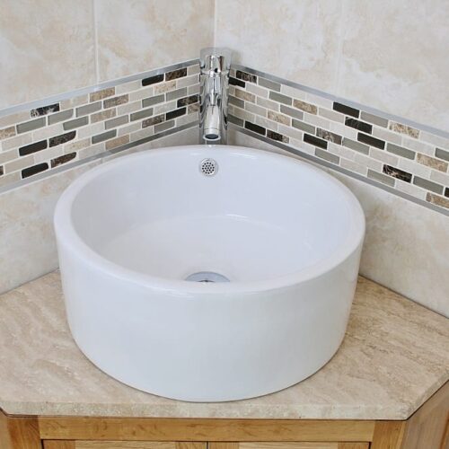 Closeup of Round Ceramic Basin on Travertine Top Vanity Unit in a Corner