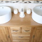Close-Up View of Two White Ceramic Bowls on Large Oak Vanity Unit