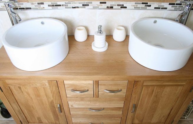 Close-Up View of Two White Ceramic Bowls on Large Oak Vanity Unit