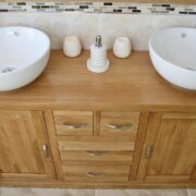 Close-UpView of Two White Ceramic Round Basins on Large Oak Vanity Unit