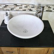 Above View of Oval White Ceramic Basin on Black Quartz Top Vanity Unit