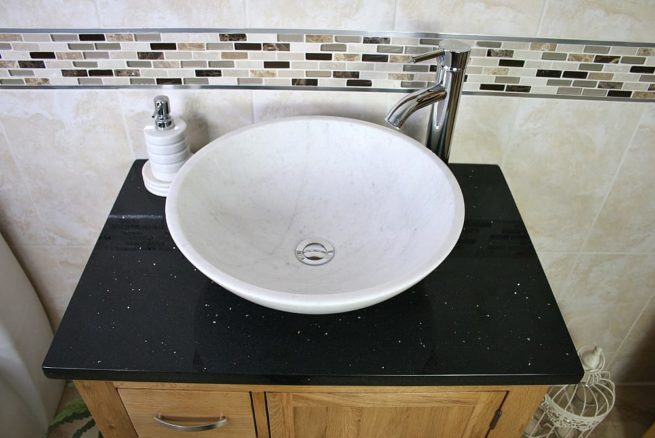 Above View of Oval White Ceramic Basin on Black Quartz Top Vanity Unit