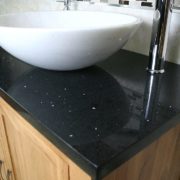 Closeup on Black Quartz Top Vanity Unit and White Oval Ceramic Basin