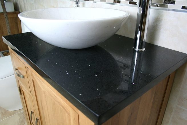 Closeup on Black Quartz Top Vanity Unit and White Oval Ceramic Basin