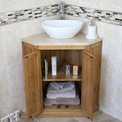 Oval Ceramic Wash Basin on Travertine Top Vanity Unit in Corner Showing Storage