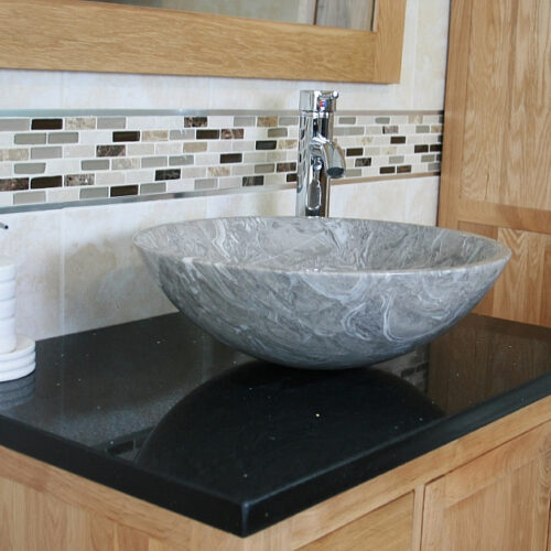 Closeup on Black Quartz Top Vanity Unit and Grey Oval Marble Basin