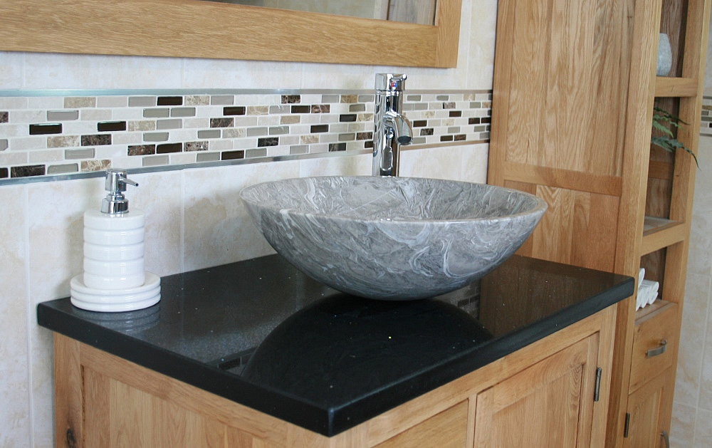 Closeup on Black Quartz Top Vanity Unit and Grey Oval Marble Basin