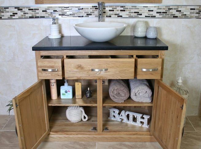 Front View of White Oval Marble Basin on Black Quartz Top Vanity Unit with Opened Doors