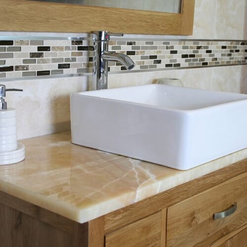 Close-Up of White Rectangle Ceramic Basin on Golden Onyx Top Vanity Unit