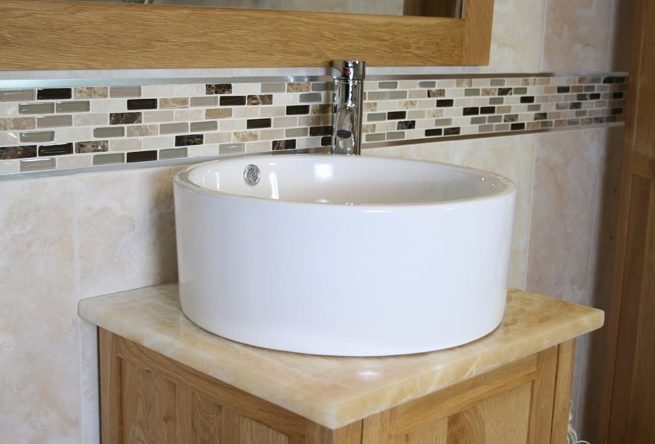 Closeup Side View of Round White Ceramic Basin on Onyx Top Vanity Unit