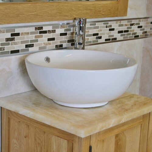 Closeup Side View of Round Curved White Ceramic Basin on Onyx Top Vanity Unit