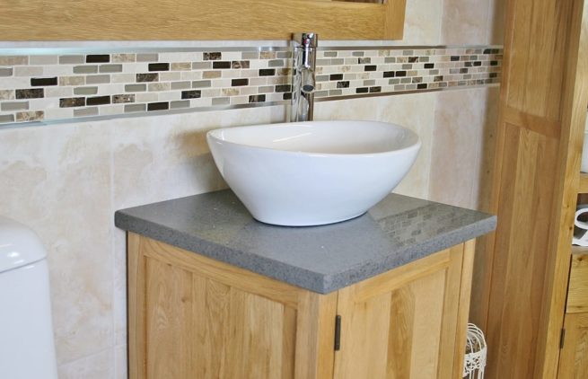 Close-up View of Oval White Ceramic Basin on Grey Quartz Topped Vanity