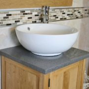 Close-up View of Round White Ceramic Basin on Grey Quartz Topped Vanity