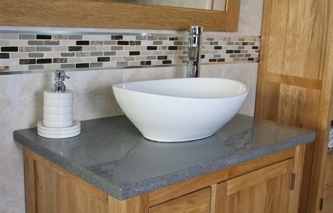 Close Up View of Oval White Ceramic Basin on Grey Quartz Top Vanity Unit