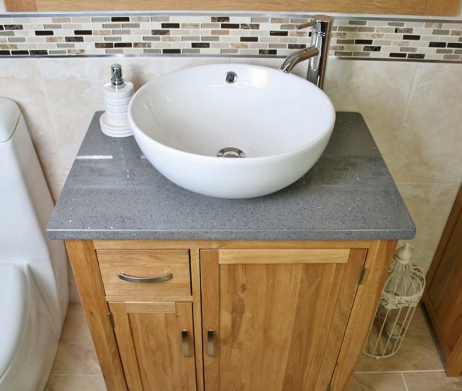 Above Closeup of Round Curved White Ceramic Basin on Grey Quartz Top Vanity Unit