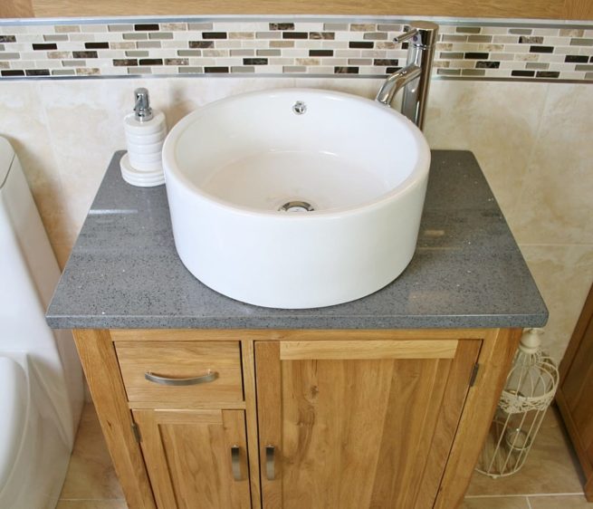 Above Close Up of Round White Ceramic Basin on Grey Quartz Top Vanity Unit