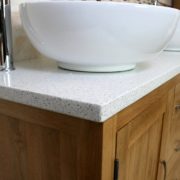 Close-up Side View of Round White Ceramic Basins on White Quartz Top Oak Bathroom Vanity