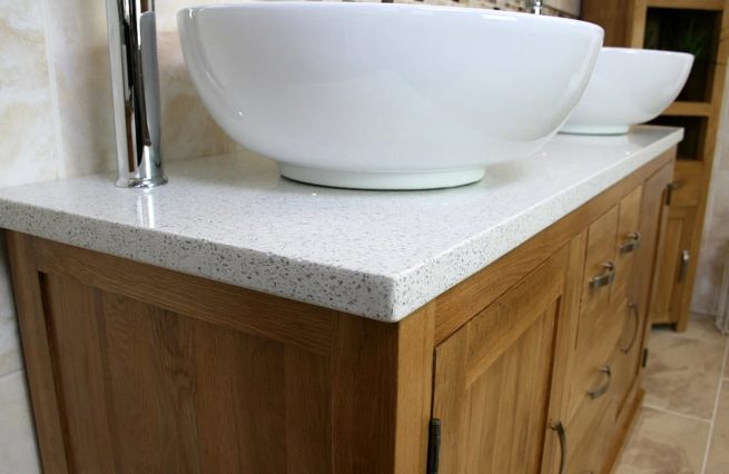 Close-up Side View of Round White Ceramic Basins on White Quartz Top Oak Bathroom Vanity