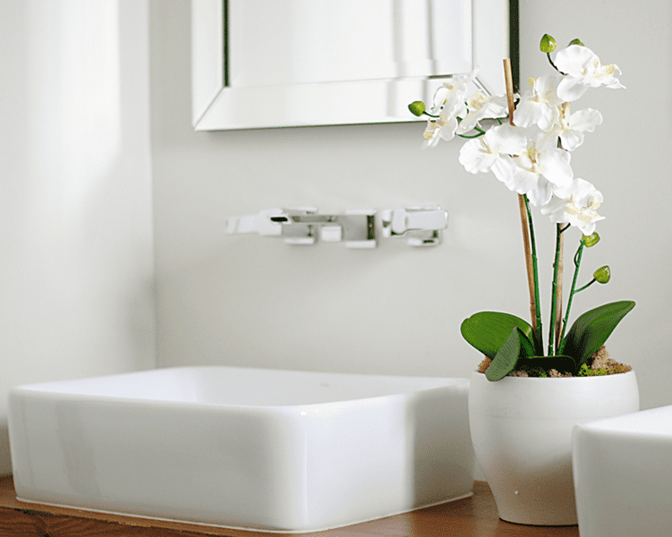 Beautiful White Orchid Complimenting a White Bathroom Sink