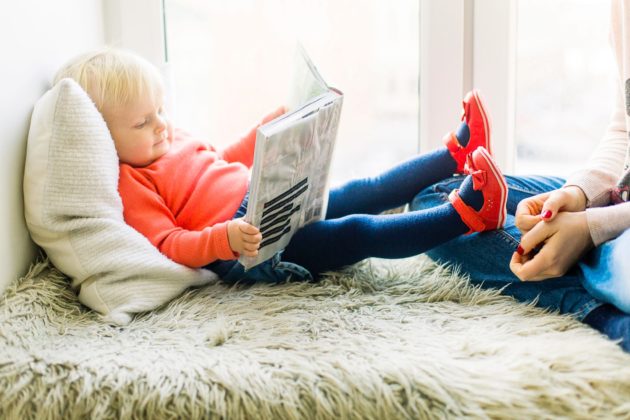 Photo of a Child Reading a Book